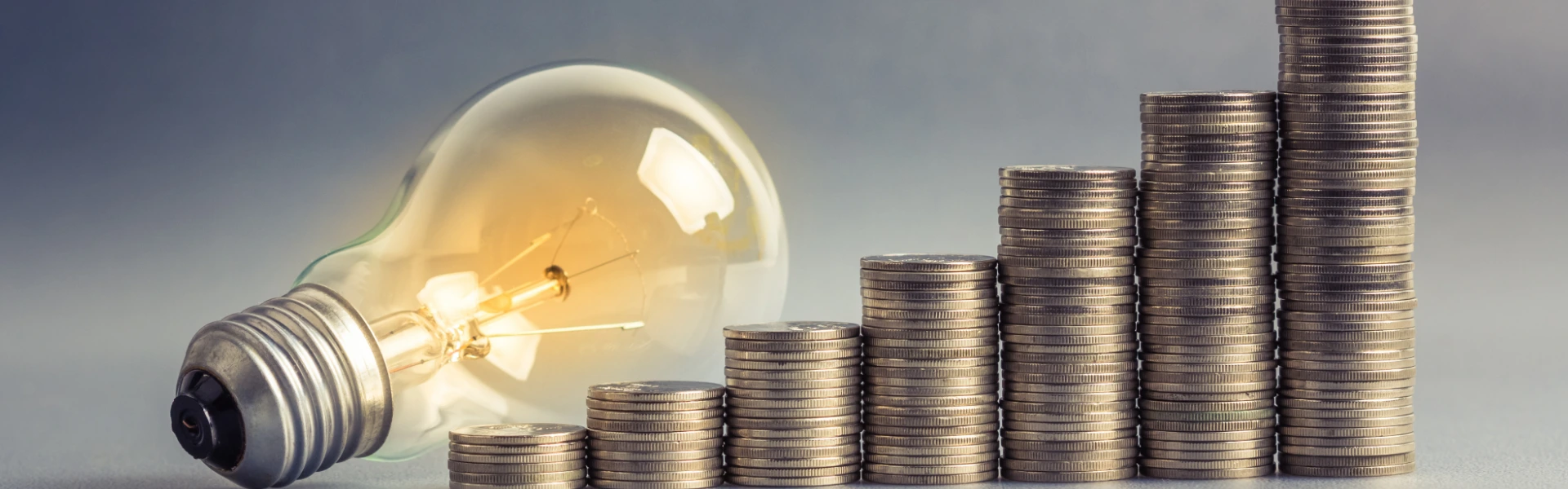 A bulb and coins signifying investment ideas in India in 2026
