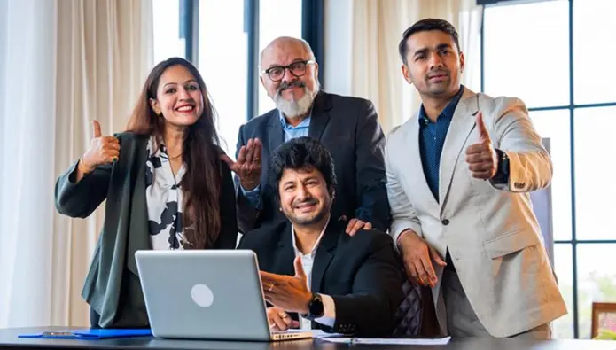 A diverse group of Indian professionals in a modern office setting